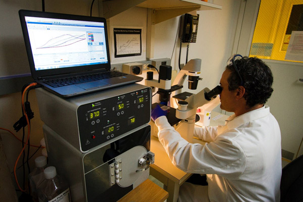 doctor-watching-inside-a-microscope doctor-watching-inside-a-microscope